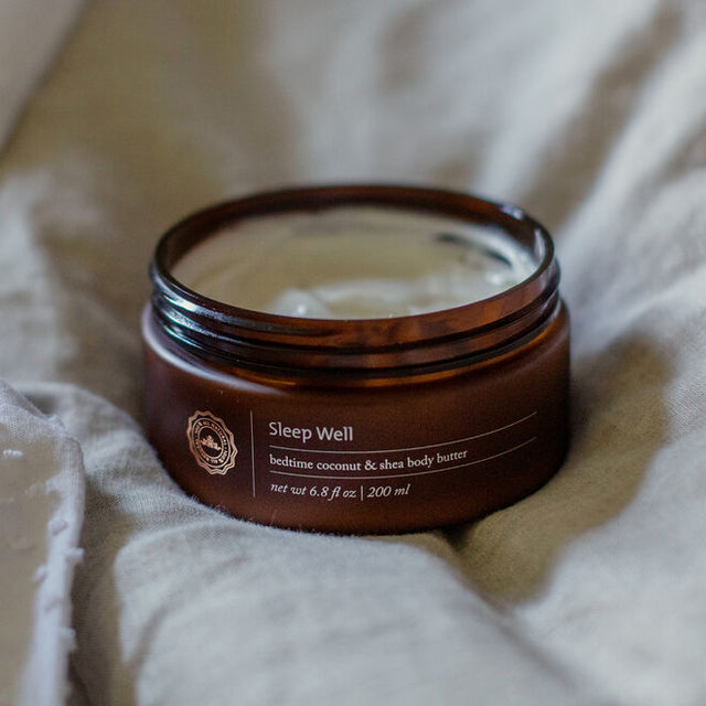Sleep Well Body Butter open on a linen sheet