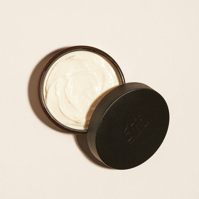 Muscle Melt body butter with lid off showing texture of body butter