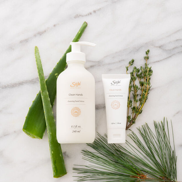 Clean Hands lotions with aloe vera, and other ingredients on a white marble surface