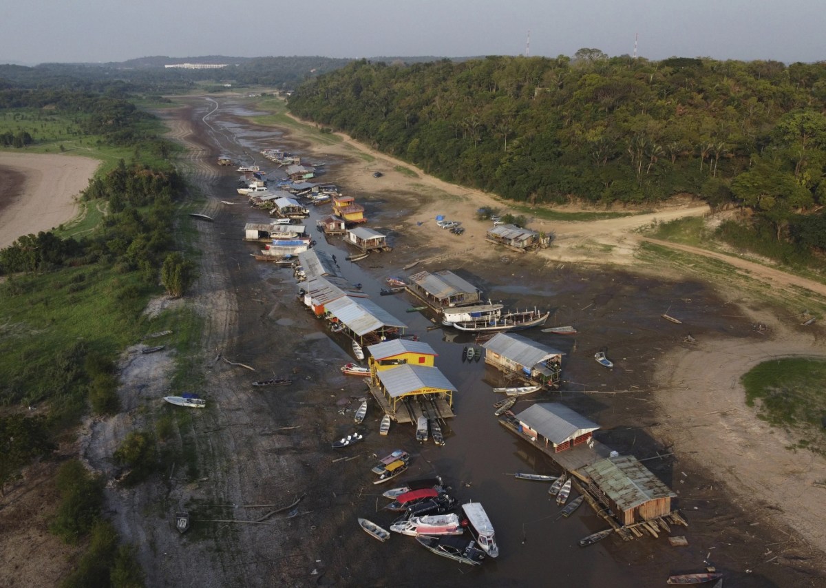 Floating homes and boats lay stranded on the dry bed of Puraquequara lake, amid a severe drought, in Manaus, Amazonas state, Brazil, Oct. 5, 2023. (AP Photo/Edmar Barros)