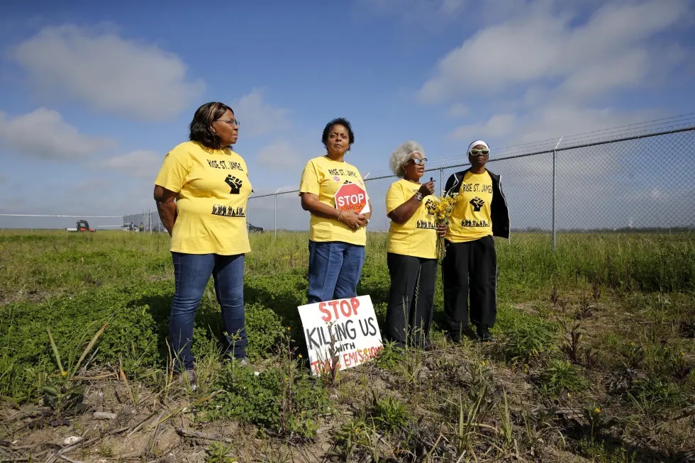 Myrtle Felton, from left, Sharon Lavigne, Gail LeBoeuf and Rita Cooper, members of RISE St. James, conduct a live stream video on property owned by Formosa on March 11, 2020, in St. James Parish, La. A Louisiana judge has thrown out air quality permits for a Taiwanese company's planned $9.4 billion plastics complex between New Orleans and Baton Rouge, Wednesday, Sept. 14, 2022, a rare win for environmentalists in a heavily industrialized stretch of the Mississippi River often referred to as "Cancer Alley."