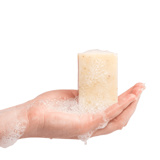 Wet Peaceful Warrior Soap Bar with soap lather being held upright by a hand